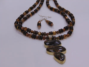20" Three chain. Two strand Smokey Quarts and glass beads with a 3 1/2" Bronzite Pendant. Matching earrings.